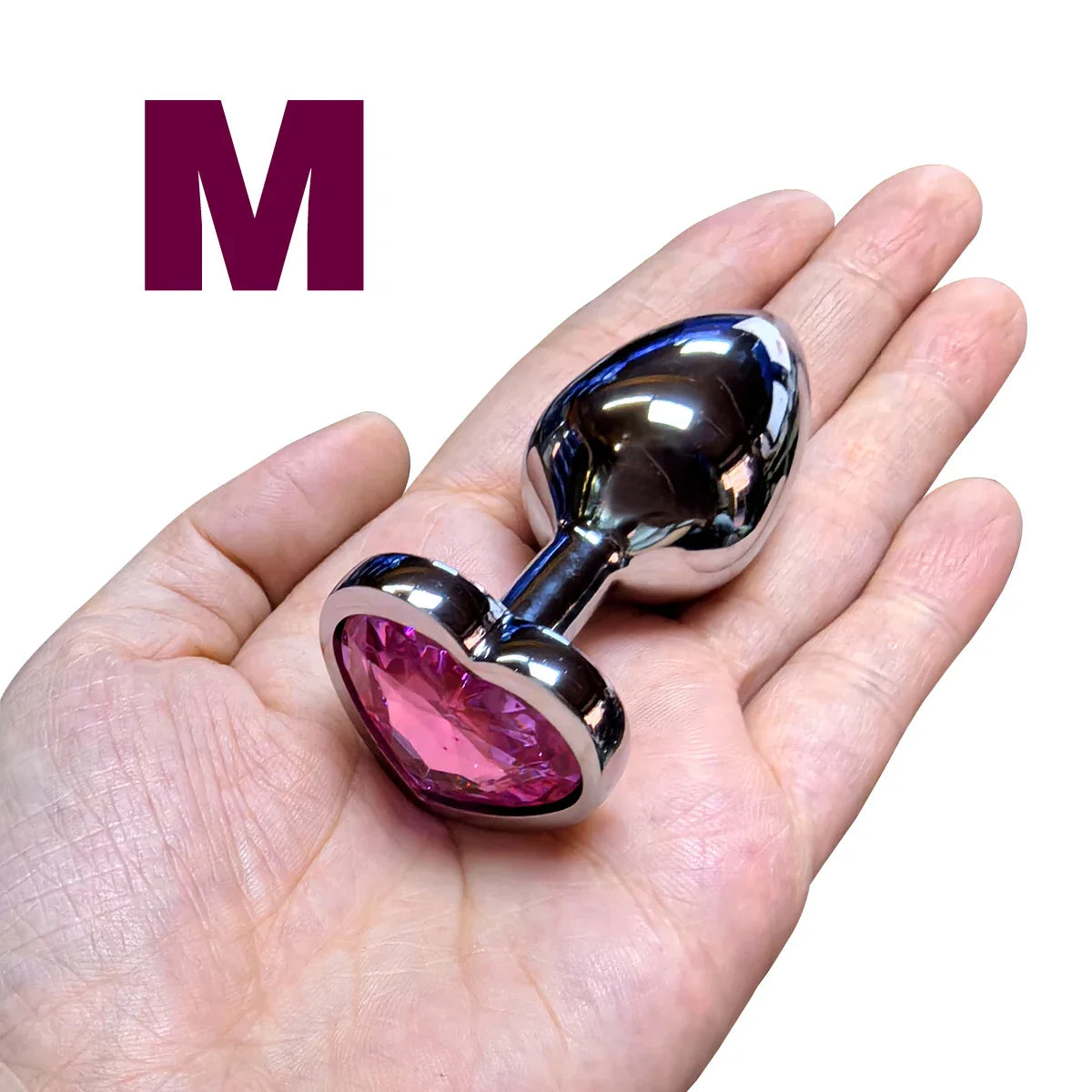 Metallic-anal-plug-with-pink-gem-on-a-hand-medium-size